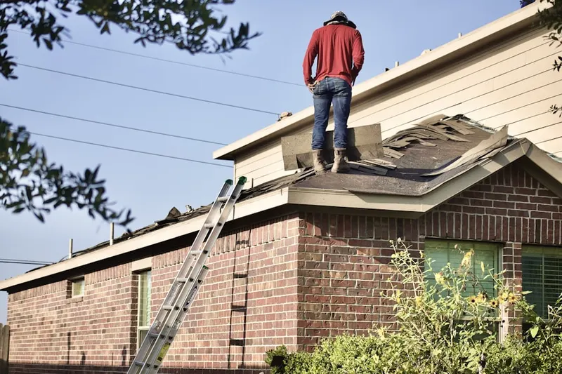 Professional roofer working on a residential roof in Shasta Lake